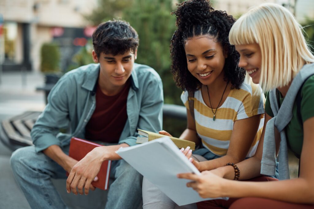 Group of happy students learning for upcoming exams together at campus.