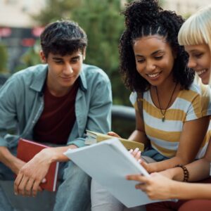 Group of happy students learning for upcoming exams together at campus.