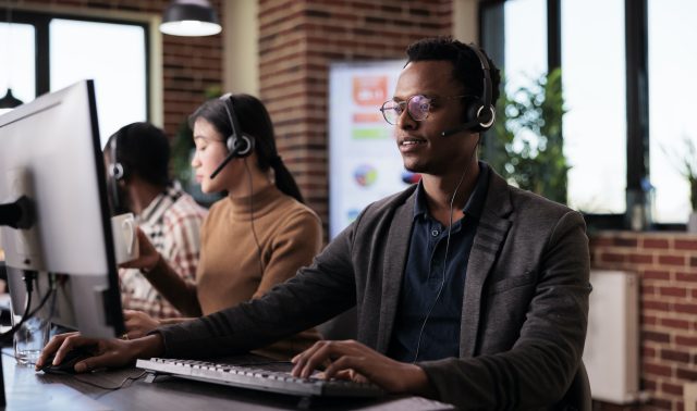 African american helpline employee working at call center